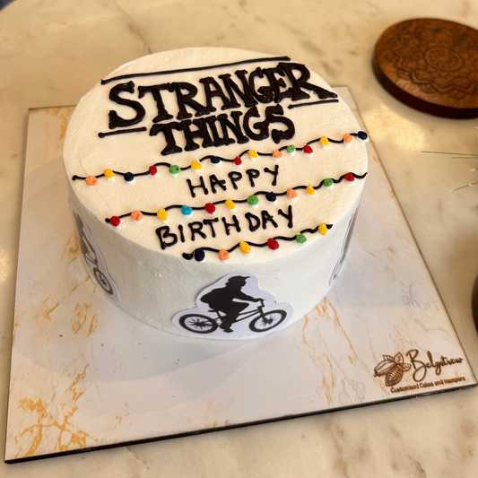 A 1kg Belgstrew Stranger Things cake featuring an edible alphabet wall with colorful lights and a miniature Eggo waffle topper.