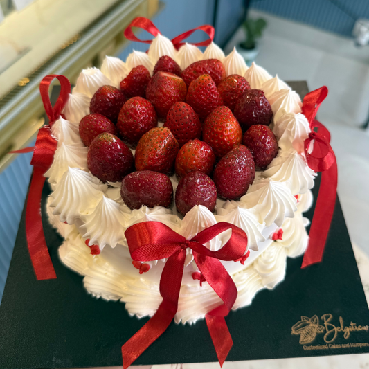 A bespoke Belgstrew Chocolate Truffle cake overflowing with fresh red strawberries and decorated with romantic gold heart accents.