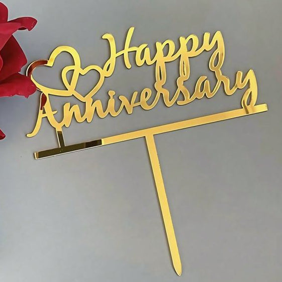 Gold 'Happy Anniversary' cake topper with a red rose on a light gray background
