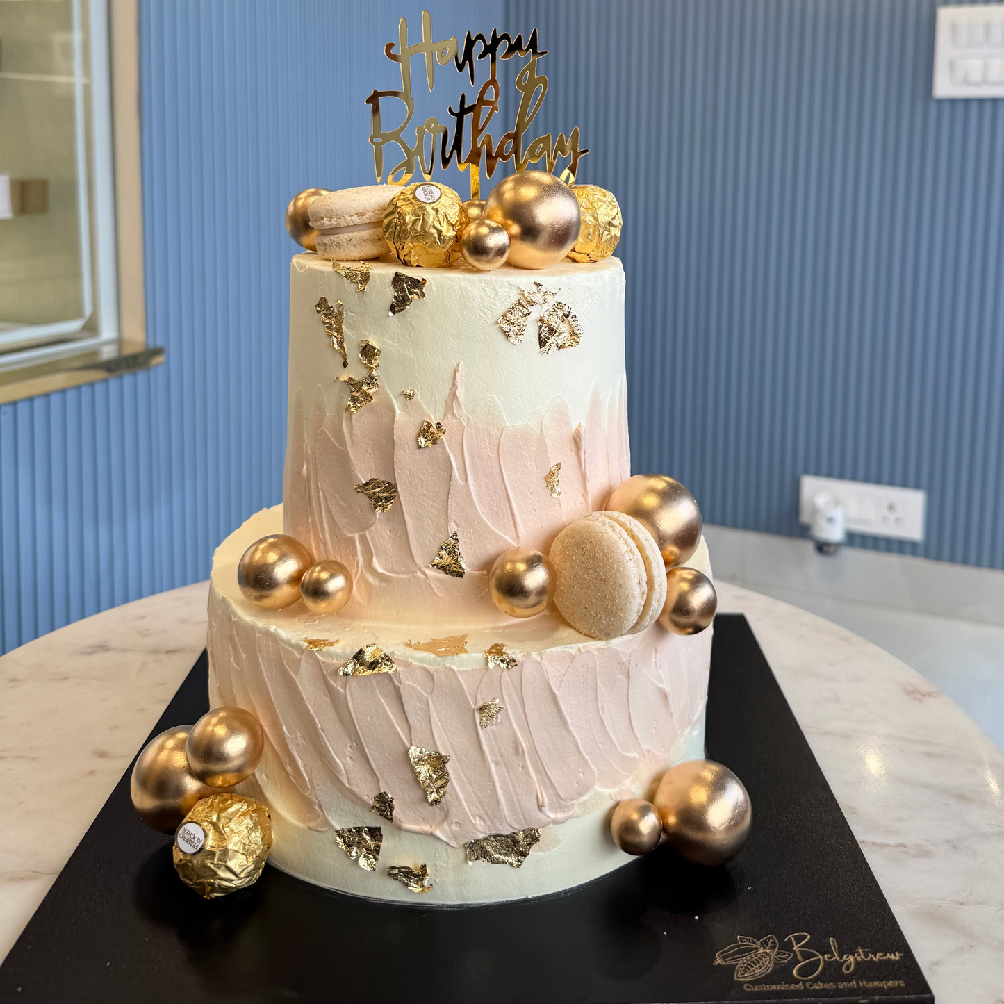 A beautifully decorated 3kg two-tier eggless cake with smooth pastel frosting and celebratory accents.