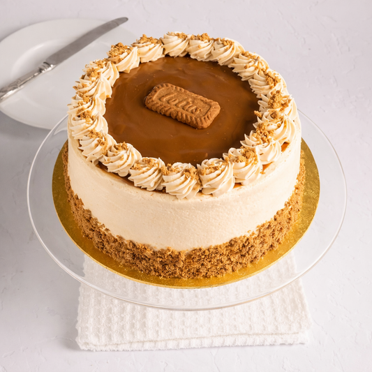 A decadent Belgstrew Biscoff Cake topped with whole Lotus biscuits and a smooth caramel-biscuit drip.