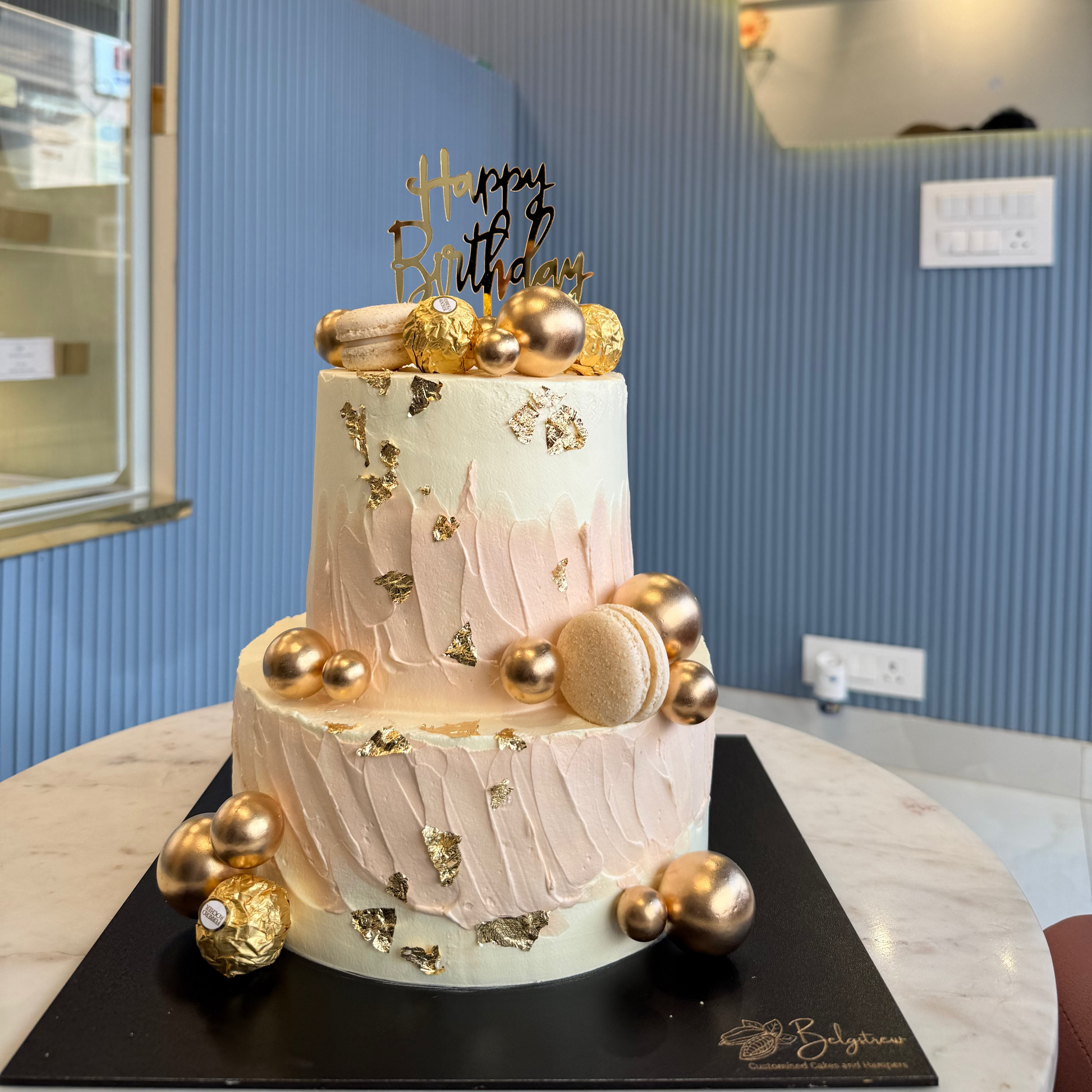 A beautifully decorated 3kg two-tier eggless cake with smooth pastel frosting and celebratory accents.