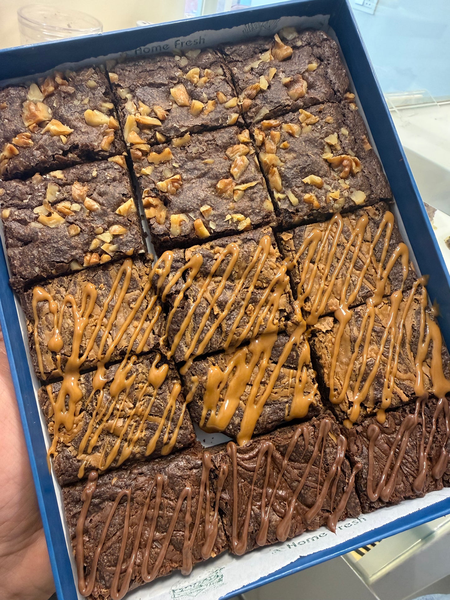 Box of brownies with caramel and chocolate drizzle