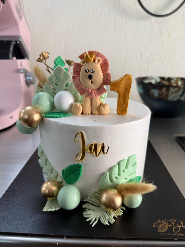 A Belgstrew Little Explorer Jungle Theme Birthday Cake with handcrafted animal and foliage design for a first birthday.