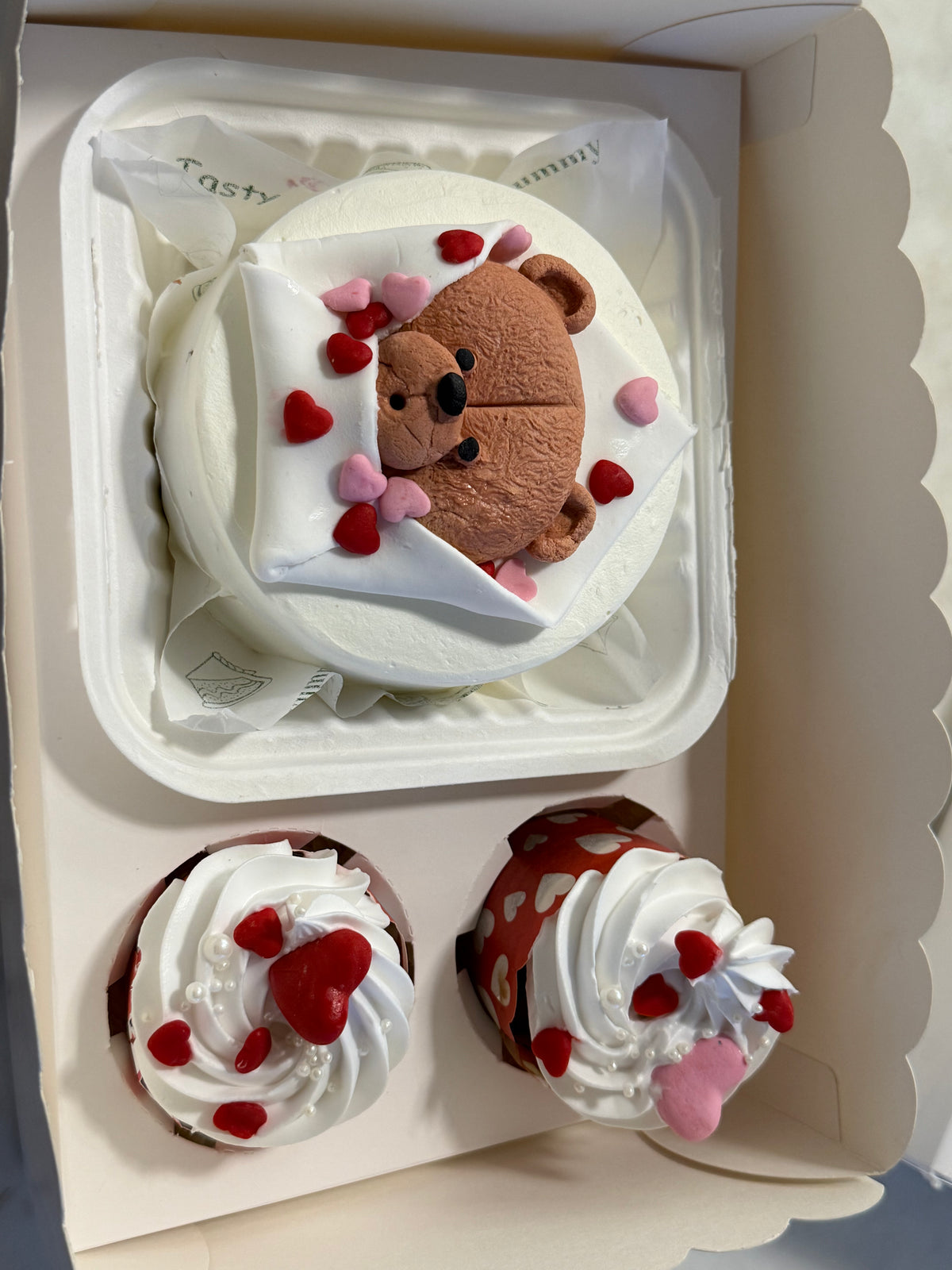 A Belgstrew Cuddle Me Valentine Bento Cake with adorable character designs and a sweet romantic message.