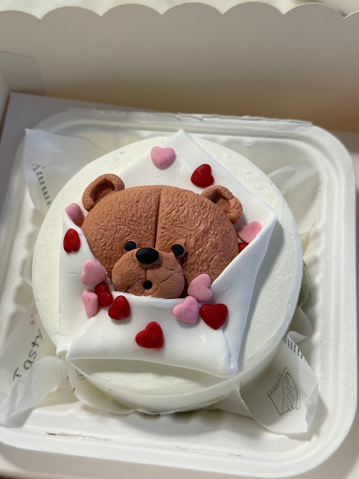 A Belgstrew Hug Me Bento Cake with a cute handcrafted character design and a warm heartfelt message.