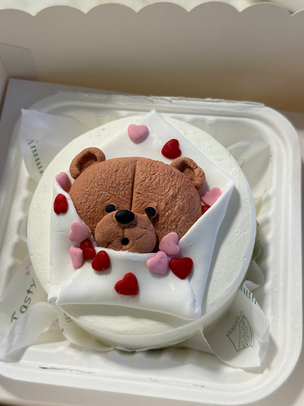 A Belgstrew Hug Me Bento Cake with a cute handcrafted character design and a warm heartfelt message.