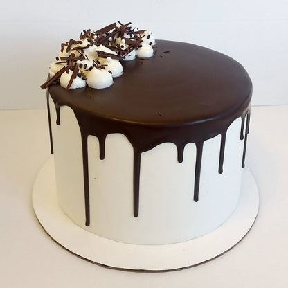 Cross-section of Belgstrew Choco-Vanilla Fusion Cake showing alternating layers of chocolate and vanilla eggless sponge.