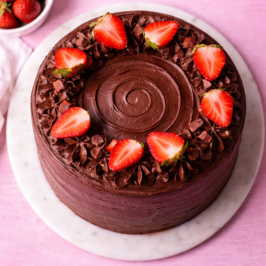 A slice of Belgstrew Chocolate Cake showing dark Belgian ganache and bright red fresh strawberry layers.
