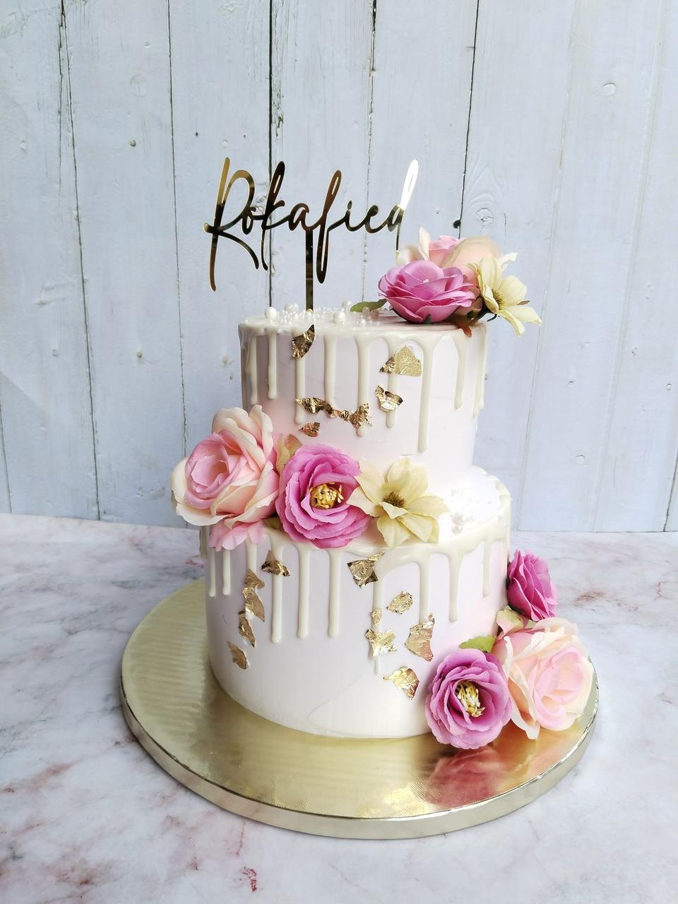 An elegant Belgstrew Floral Drip Wedding Tier Cake with cascading fresh blooms and a smooth cream finish.