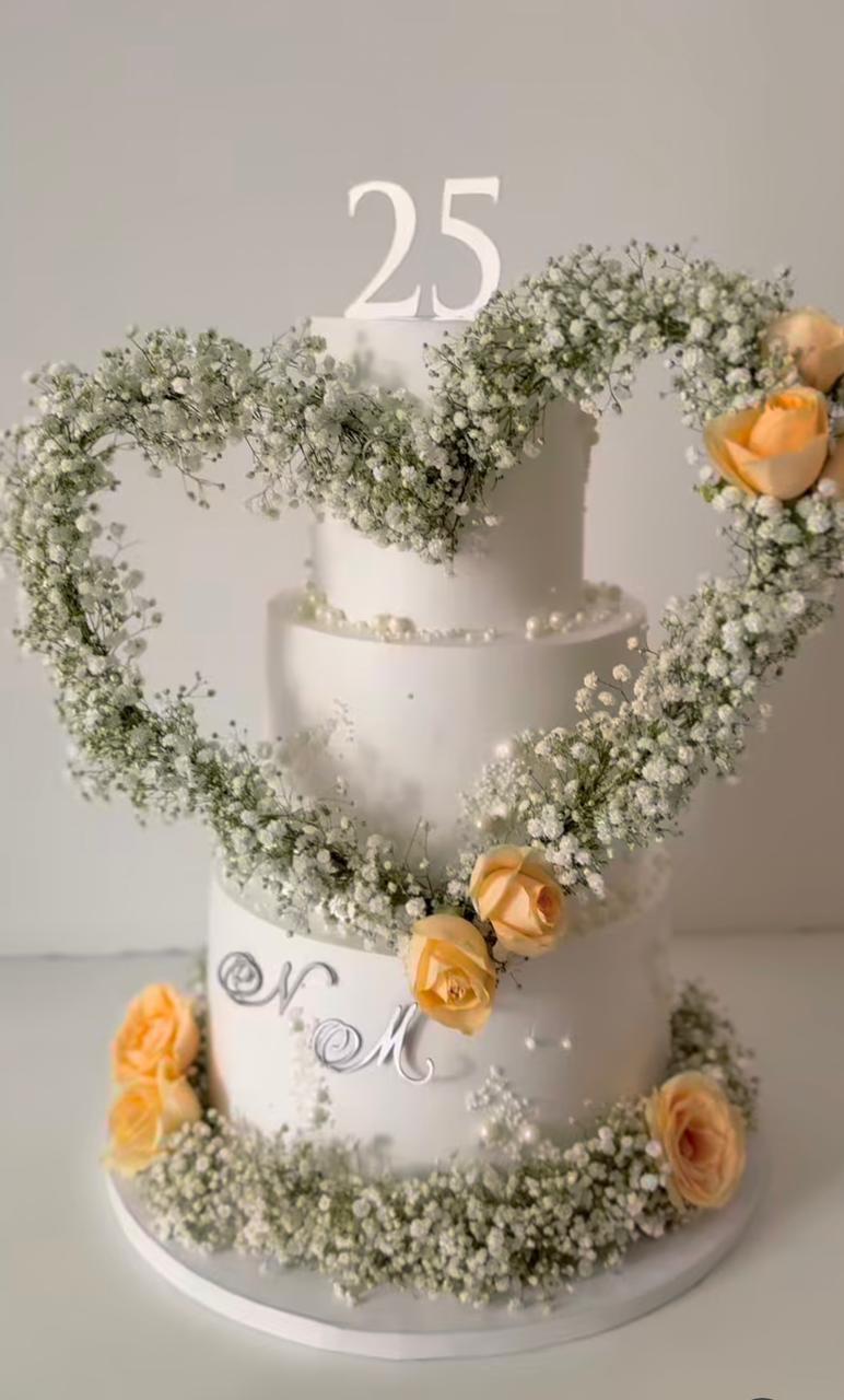 A Belgstrew Heart Floral Hoop Tier Cake decorated with fresh flowers and seasonal fruit for a milestone celebration.