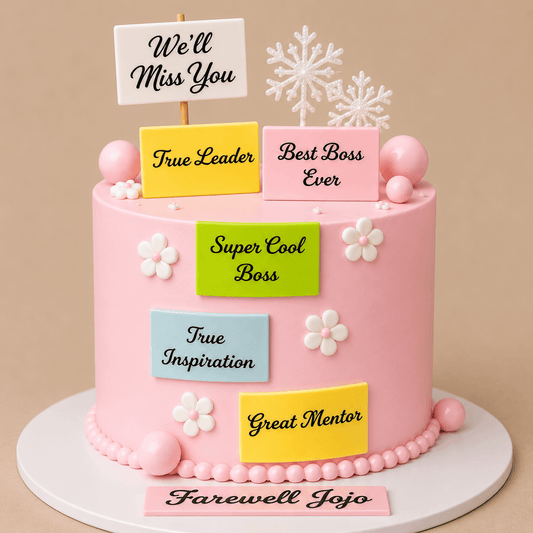 A tall round premium pastel pink corporate farewell cake decorated with small white flowers, featuring five colorful message plaques reading True Leader, Best Boss Ever, Super Cool Boss, True Inspiration, and Great Mentor, topped with a sign reading We'll Miss You and a name card reading Farewell Jojo.