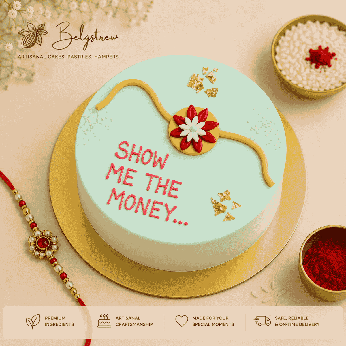A round pastel mint green celebration cake topped with a handcrafted floral rakhi, edible gold leaf flakes, and pink piped lettering reading Show Me The Money.